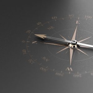 Golden compass over modern black background. Concept of business guidance or orientation, 3D illustration.